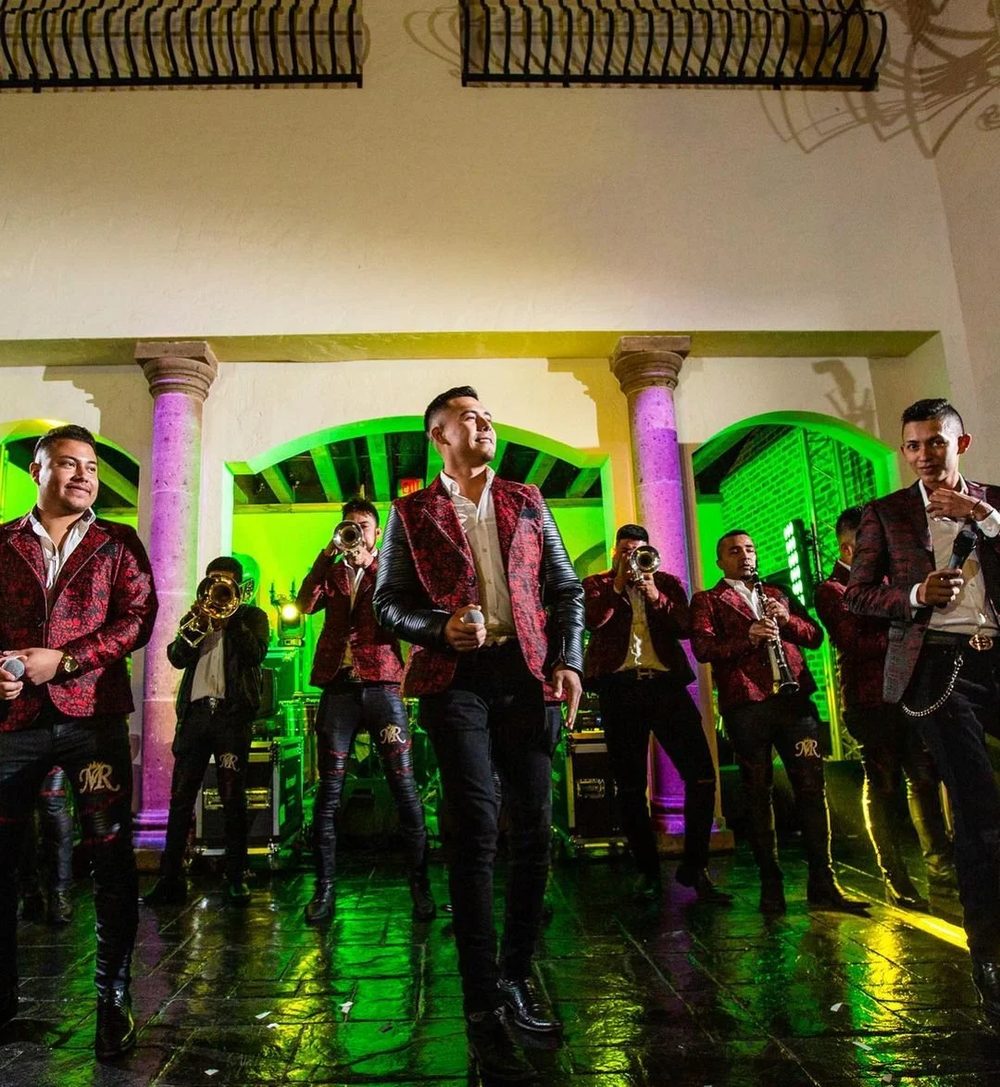 Live band in red sequined jackets performing for a quinceañera reception on the dance floor at The Bell Tower on 34th, Houston, TX.